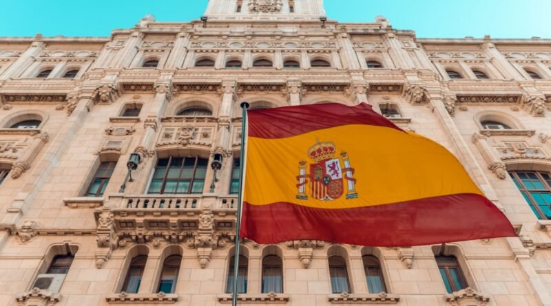 flag on pole beside building during day