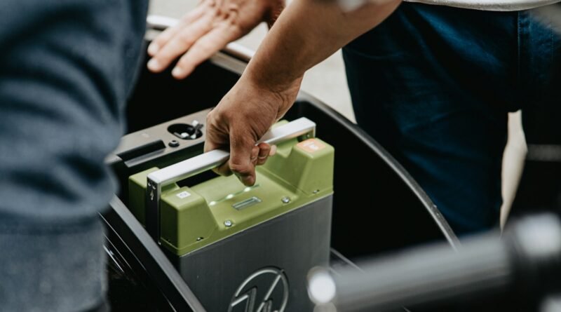 person holding black and green electronic device